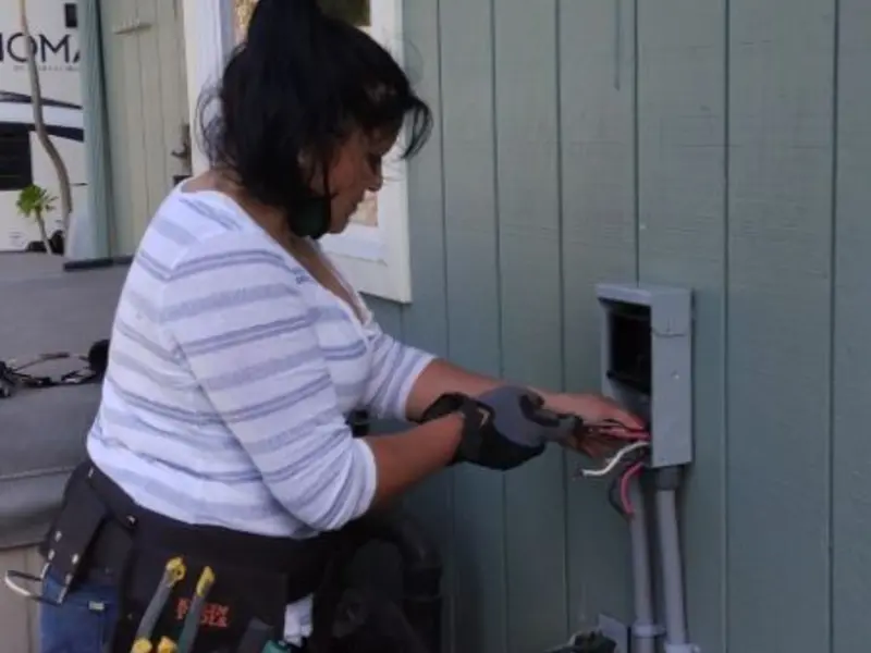 Licensed electrician wiring an exterior subpanel in Lake Wildwood